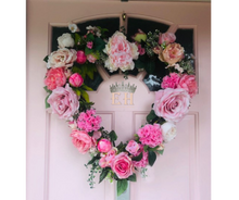 Load image into Gallery viewer, Heart shaped door wreath with real look pale pink faux roses, faux peonies, faux hydrangeas and gypsophila with green foliage. 
