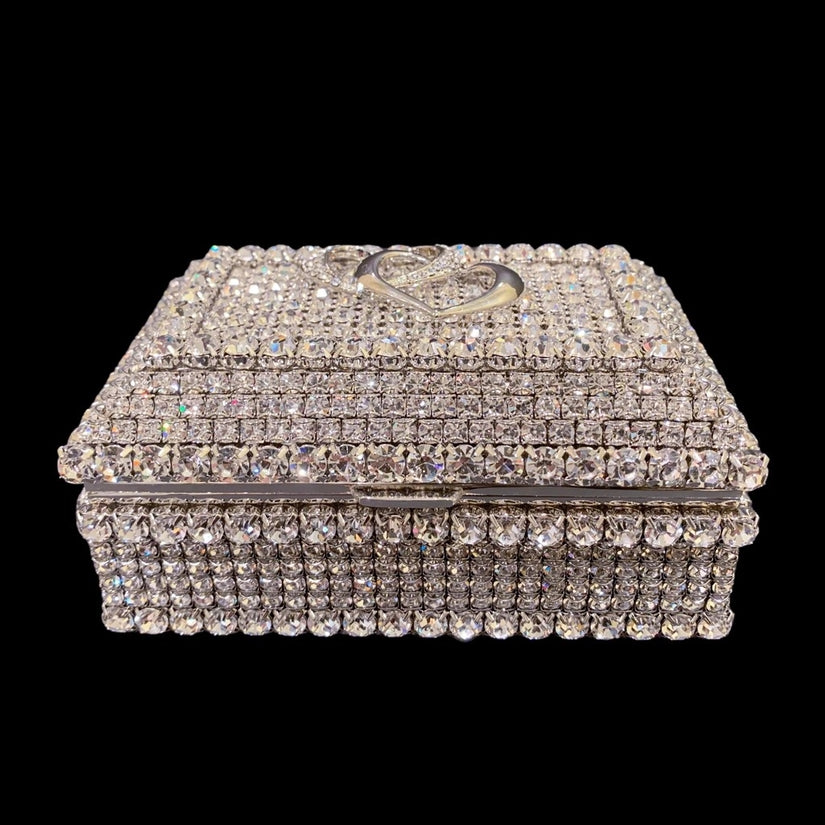 Glittering keepsake box covered in swarovski crystals. Two interlocking hearts on the top of the box.