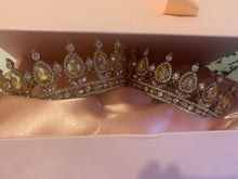 Load image into Gallery viewer, Two diamanté sparkling crowns set with oval champagne coloured stones, in a pink box with a silky pink lining inside the box and a pink bow to tie and secure the box closed. 
